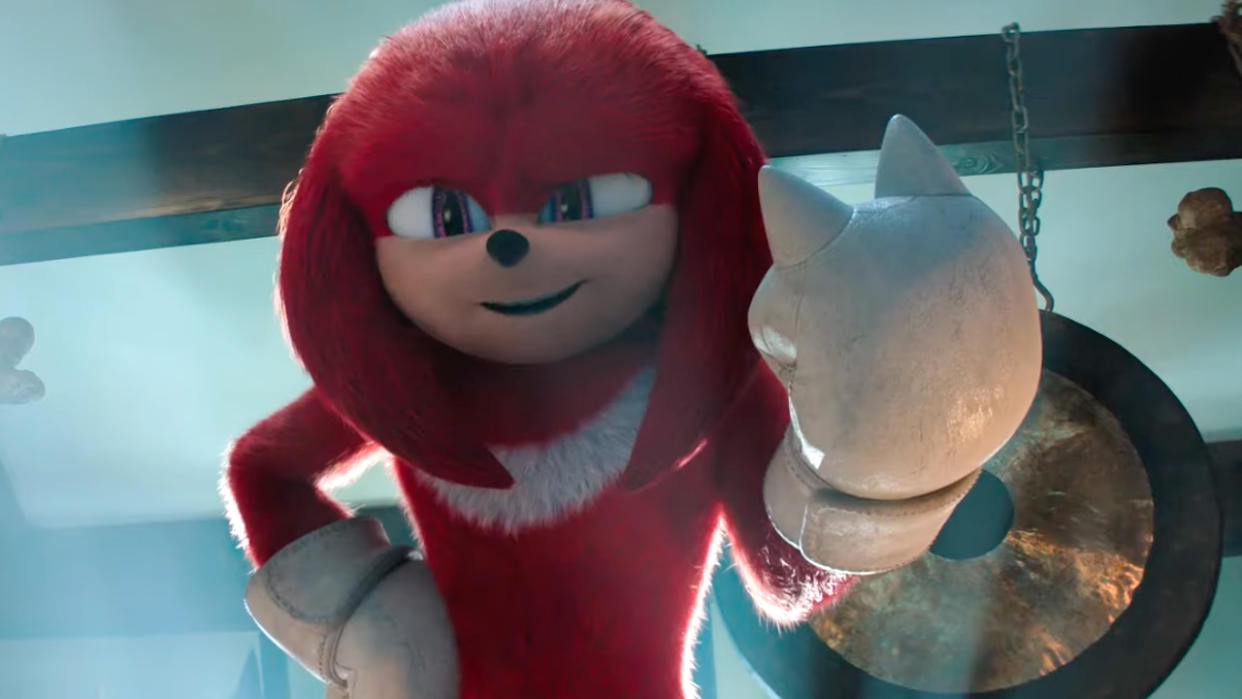  Knuckles smiles and holds his left fist up in the air in his self-titled TV series, aka one of the best Paramount Plus shows. 