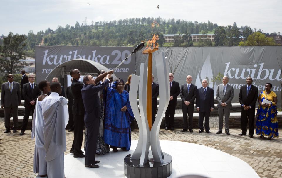 Rwandan President Paul Kagame and UN Secretary-General Ban Ki-moon, center-left, light a memorial flame at a ceremony to mark the 20th anniversary of the Rwandan genocide, held at the Kigali Genocide Memorial Center in Kigali, Rwanda Monday, April 7, 2014. (AP Photo/Ben Curtis)