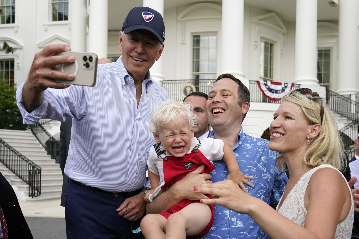 President Joe Biden snaps a photo with guests at the White House Congressional Picnic on the South Lawn of the White House on Tuesday, July 12, 2022, in Washington, DC.