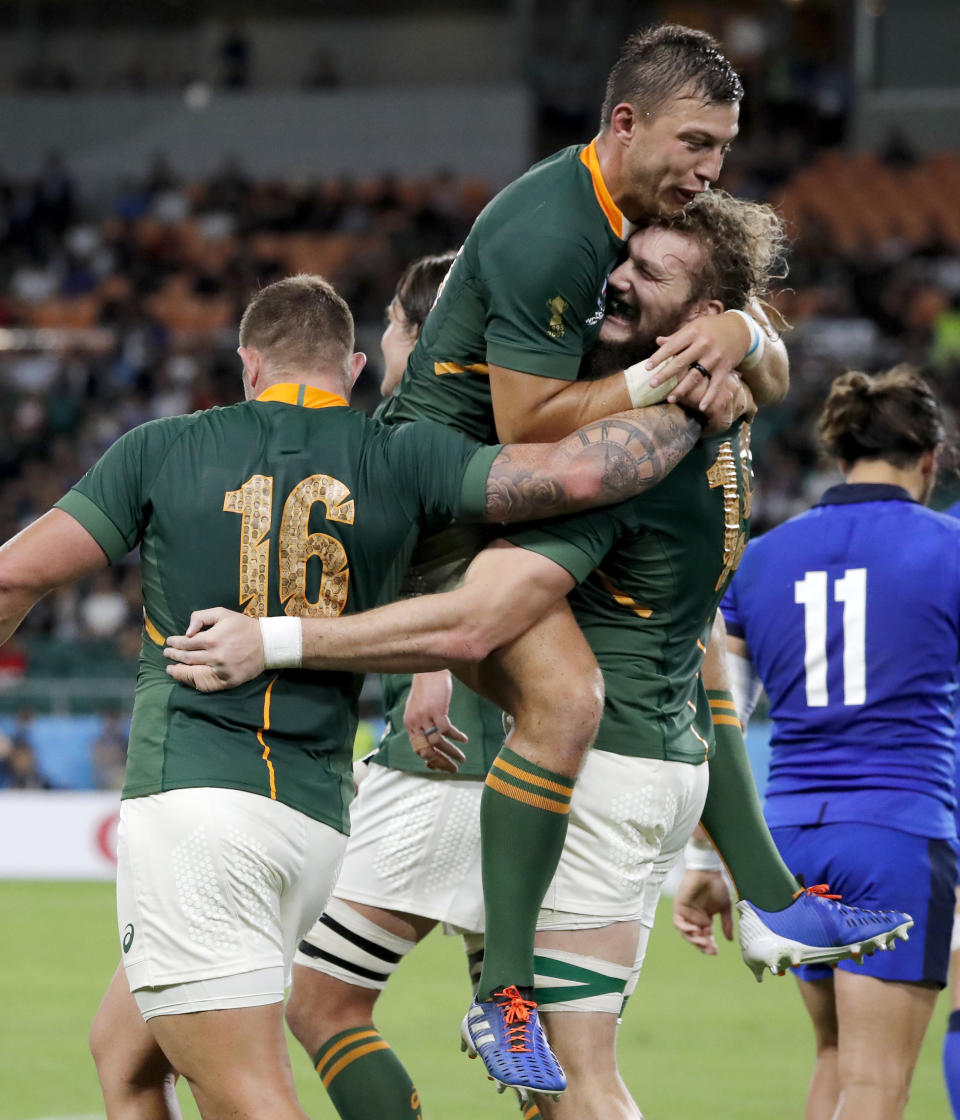 South Africa's RG Snyman is congratulated by teammates Handre Pollard and Malcolm Marx, left, after scoring a try during the Rugby World Cup Pool B game at Shizuoka Stadium Ecopa between South Africa and Italy, in Shizuoka, Japan, Friday, Oct. 4, 2019. (AP Photo/Shuji Kajiyama)