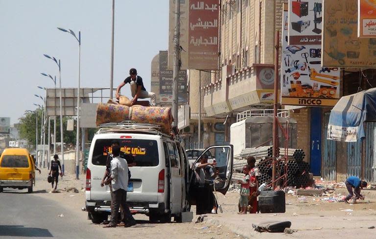 Yemeni's pack their belongings as they flee from the southern city of Aden on March 30, 2015 while Arab coalition warplanes continue to carry out air strikes against Shiite Huthi rebels