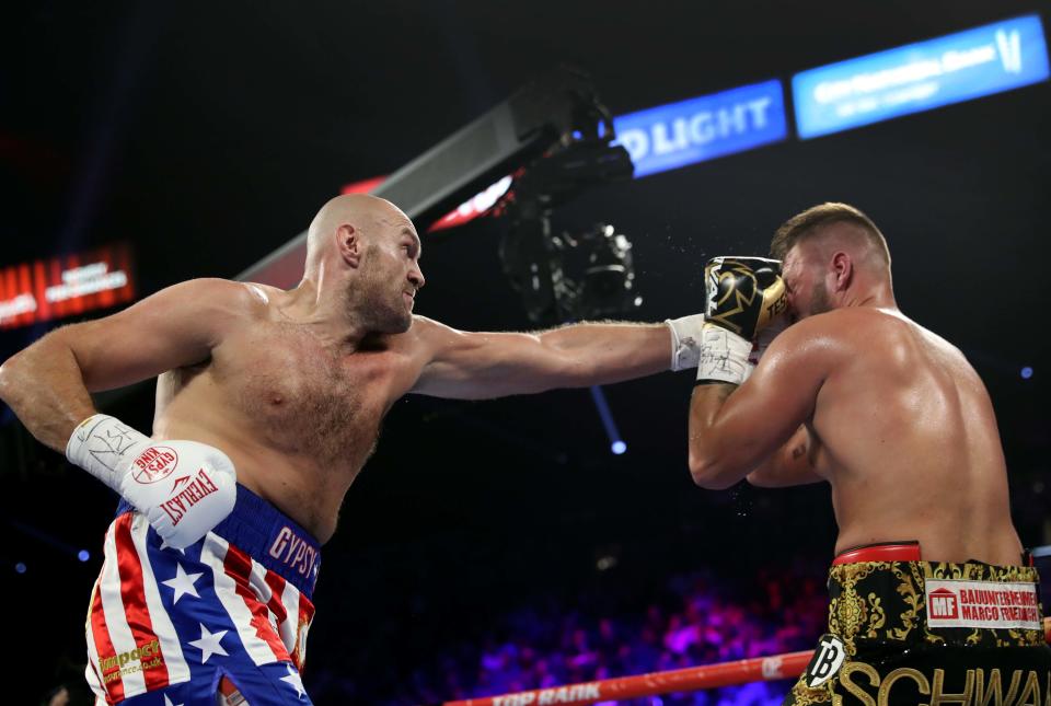 LAS VEGAS, NEVADA - JUNE 15:  Tyson Fury (L) connects with a punch on Tom Schwarz during a heavyweight fight at MGM Grand Garden Arenaon June 15, 2019 in Las Vegas, Nevada. Fury won with a second-round TKO. (Photo by Steve Marcus/Getty Images)