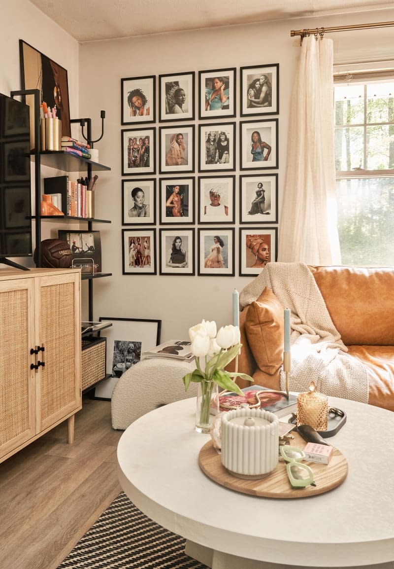 gallery wall and leather armchair with round coffee table in white living room