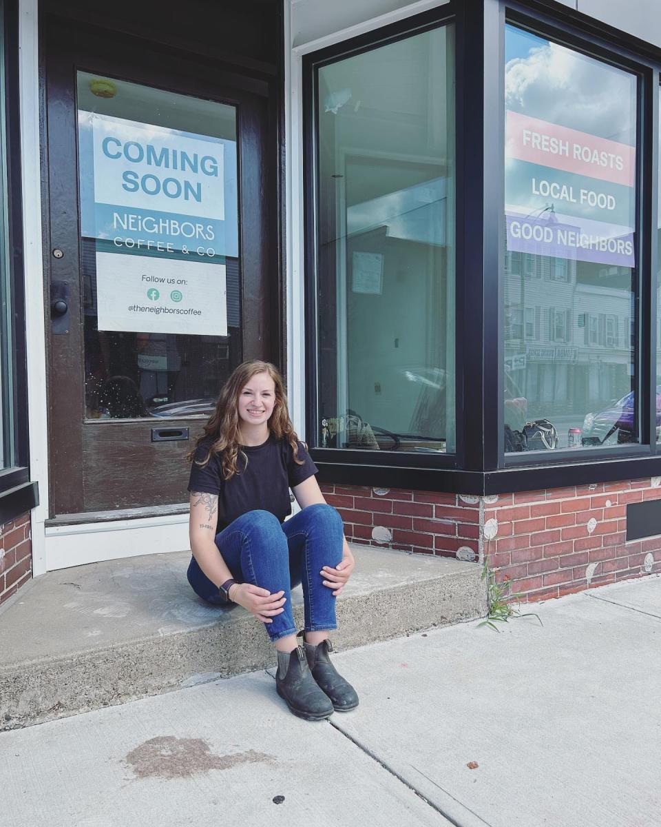 Rachel Correia, owner of The Neighbors Coffee and Co., sitting in front of her cafe and storefront, located at 32 Weir St. in Taunton, in 2023.