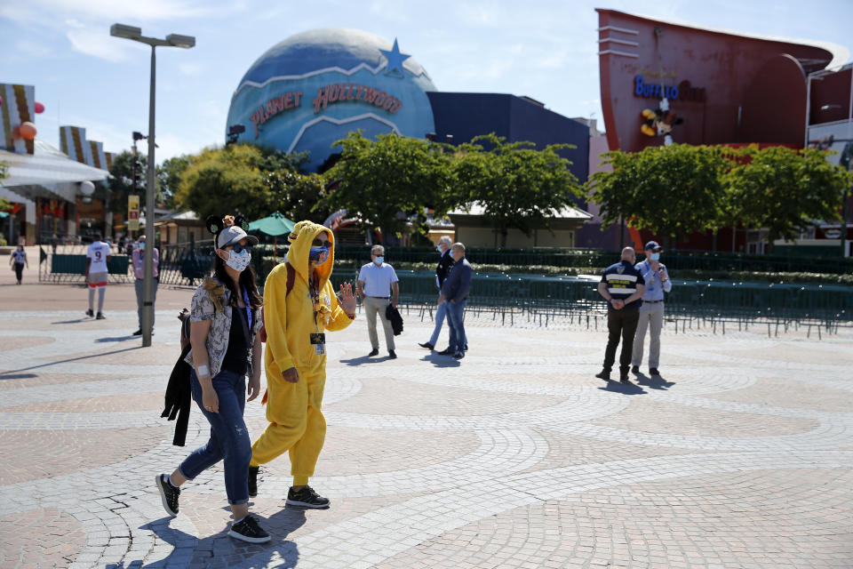 PARIS, FRANCE - JULY 13: People with annual passes wearing protective face masks arrive to visit Disneyland Paris on July 13, 2020 in Marne-la-Vallee, near Paris, France. After four months of closure, the amusement park officially reopens its doors on Wednesday July 15 with compulsory reservations online. The Disneyland Paris and Walt Disney studio parks have been closed since mid-March due to the coronavirus epidemic (COVID 19). (Photo by Chesnot/Getty Images)