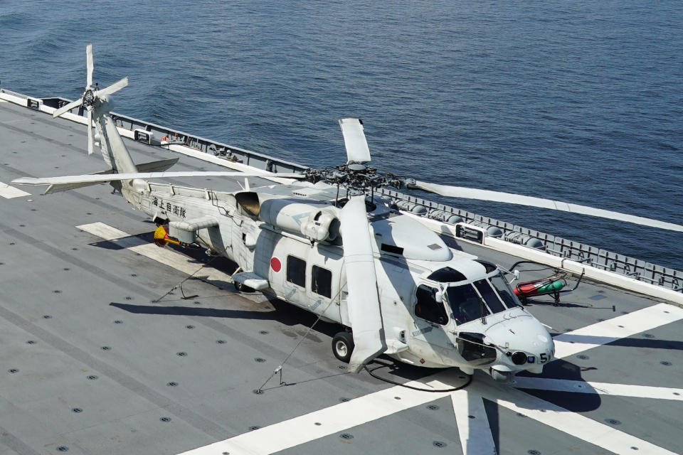 FILE - An SH-60K anti-submarine helicopter sits on the flight deck of Japan's Maritime Self Defense Force (JMSDF) helicopter carrier JS Izumo (DDH-183) off the coast of Brunei on June 26, 2019. Late Saturday, April 20, 2024, contact was lost with two Japanese navy SH-60K choppers carrying eight crewmembers, believed to have crashed in the Pacific Ocean south of Tokyo during a night-time training exercise, and rescuers were searching for the missing, Japan’s defense minister said. (AP Photo/Emily Wang, File)