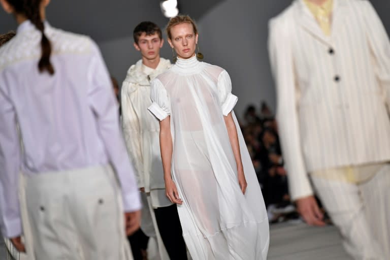 Models present creations for fashion house Jil Sander designed by husband and wife duo Luke and Lucie Meier
