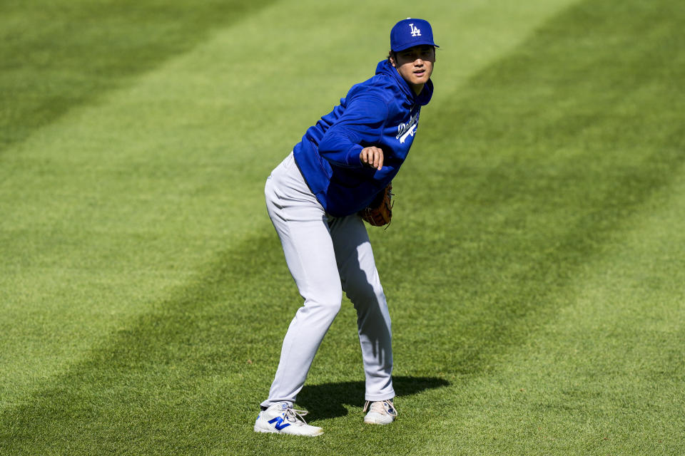 Los Angeles Dodgers' Shohei Ohtani reacts as he throws before a baseball game against the Washington Nationals at Nationals Park, Tuesday, April 23, 2024, in Washington. (AP Photo/Alex Brandon)