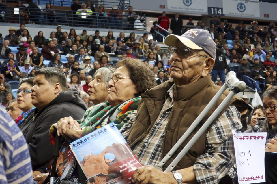 John Nez, right, and Mabel Nez, seated to his right, attend the Navajo Nation inauguration on Tuesday, Jan. 15, 2019, in Fort Defiance, Ariz. Their son, Jonathan Nez, was sworn in as the tribal president. (AP Photo/Felicia Fonseca)