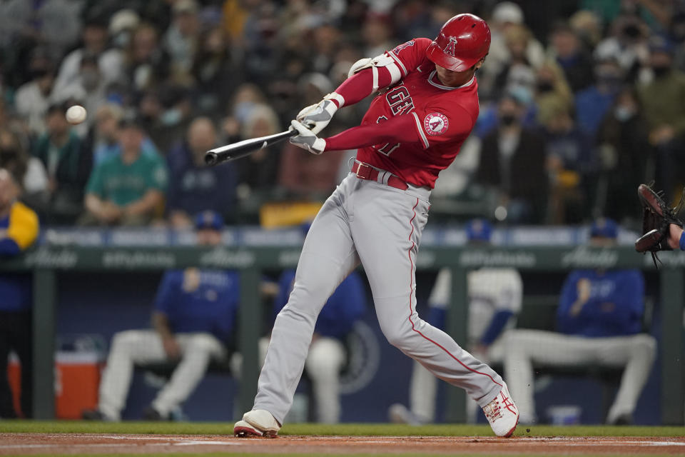 Los Angeles Angels' Shohei Ohtani hits a solo home run during the first inning of a baseball game against the Seattle Mariners, Sunday, Oct. 3, 2021, in Seattle. (AP Photo/Ted S. Warren)