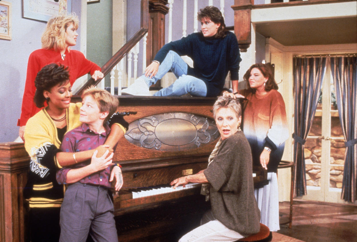 Cast members from the television series 'The Facts of Life' stand around a piano, circa 1987.  (L-R front) Kim Fields, MacKenzie Astin and Cloris Leachman.  (L-R rear) Lisa Welchel, Nancy McKeon and Mindy Cohn.  (Photo by NBC Television/Courtesy of Getty Images)