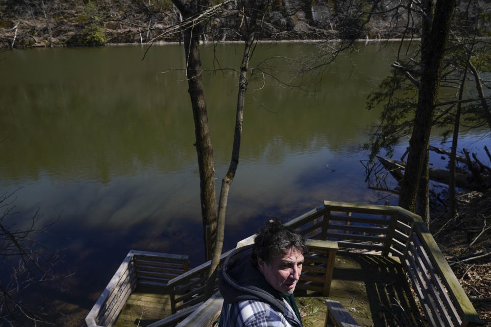 Michael Vallarella shows reporters a section of the Esopus Creek near his house in Saugerties, N.Y., Tuesday, April 5, 2022. As western regions contend with drier conditions, New York City is under fire for sometimes releasing hundreds of millions of gallons of water a day from the Ashokan reservoir in the Catskill Mountains. The occasional releases, often around storms, have been used to manage water the reservoir's levels and to keep the water clear. But residents downstream say the periodic surges cause ecological harm along the lower Esopus Creek. (AP Photo/Seth Wenig)