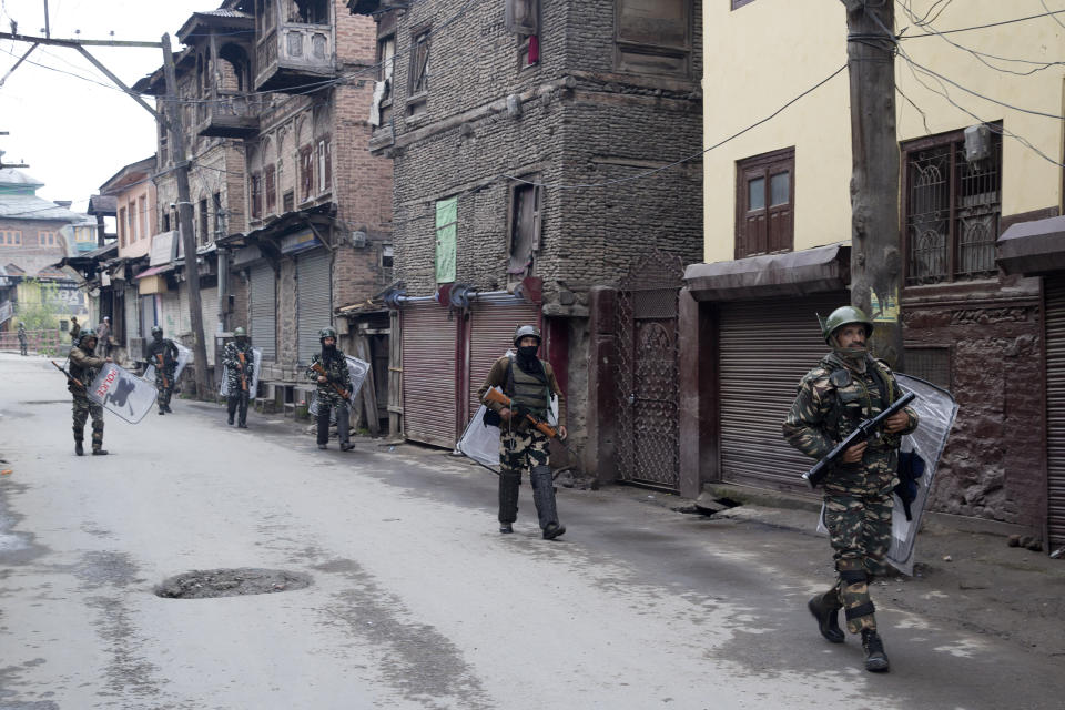 FILE - In this April 18, 2019, file photo, Indian paramilitary soldiers patrol a deserted street during the second phase of India's general elections, in Srinagar, Indian controlled Kashmir, after Kashmiri separatist leaders who challenge India's sovereignty over the disputed region called for a boycott of the vote. The final phase of India’s marathon general election will be held on Sunday, May 19. The first of the election’s seven staggered phases was held on April 11. Vote counting is scheduled to start on May 23. India has 900 million eligible voters. (AP Photo/ Dar Yasin, File)