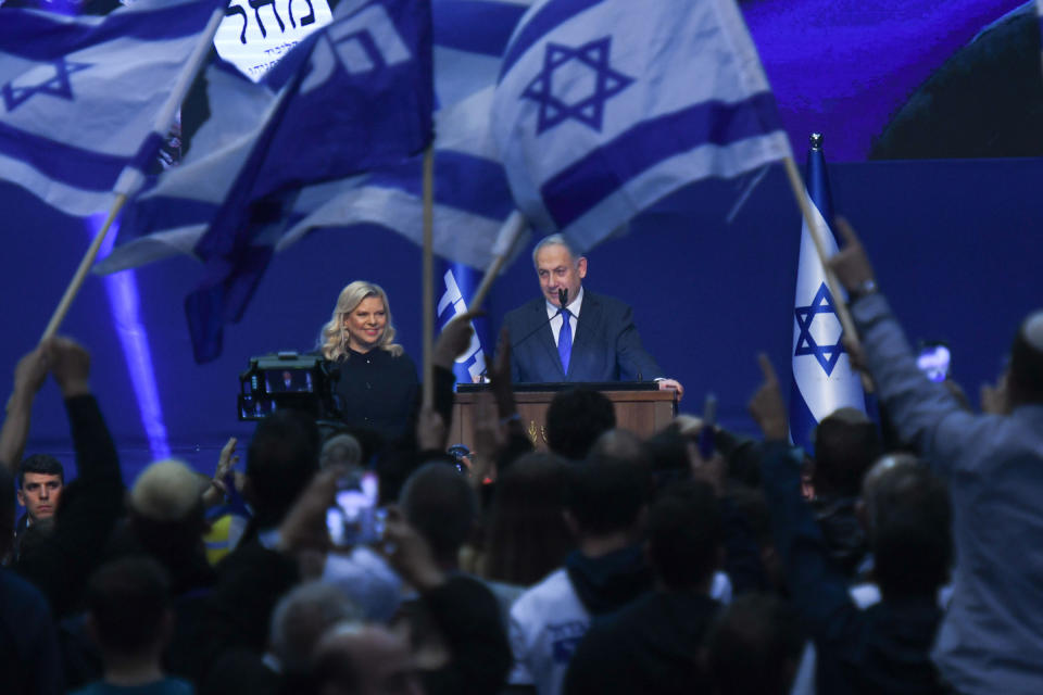 Israeli Prime Minister Benjamin Netanyahu stands next to his wife Sara as he speaks to supporters following the announcement of exit polls in Israel's election at his Likud party headquarters in Tel Aviv. on March 3, 2020.<span class="copyright">Artur Widak—NurPhoto/Getty Images</span>