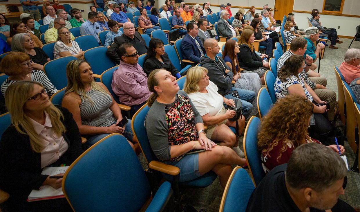 Kristin Pecoraro, center, breathes a sigh of relief after a Polk County Planning Board voted 4-3 to deny the building of an HCA hospital between Valleyview Elementary School and George Jenkins HIgh School in South Lakeland on Wednesday.