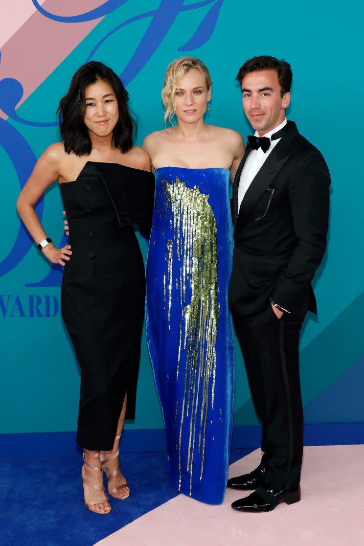 Laura Kim and Fernando Garcia of Monse pose with Diane Kruger wearing one of their designs at the 2017 CFDA awards. (Photo: Getty Images)