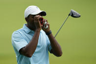 Wyatt Worthington II check his yardage on the second hole during a practice round for the PGA Championship golf tournament, Tuesday, May 17, 2022, in Tulsa, Okla. (AP Photo/Eric Gay)