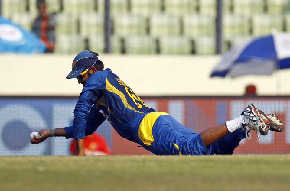 Sri Lanka’s Lahiru Thirimanne catches the ball resulting in the dismissal of Bangladesh’s Anamul Haque during the Asia Cup one-day international cricket tournament in Dhaka, Bangladesh, Thursday, March 6, 2014. (AP Photo/A.M. Ahad)