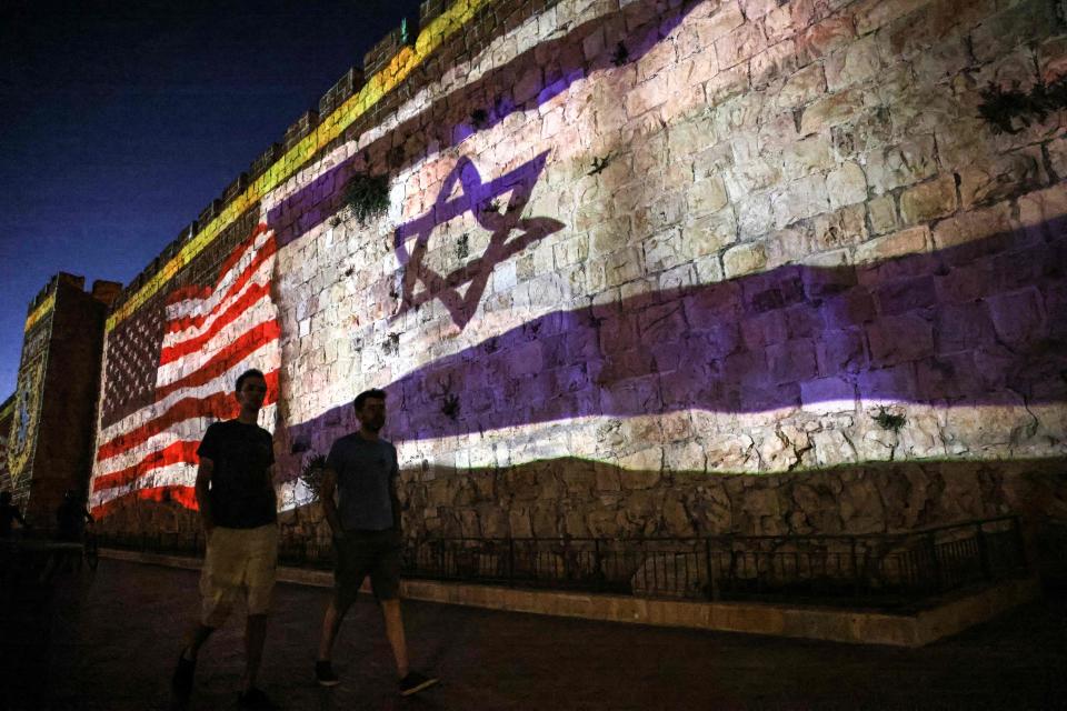 The Israeli and US flags are projected agaist the wall of the old city of Jerusalem during the visit of the US president, on July 13, 2022.