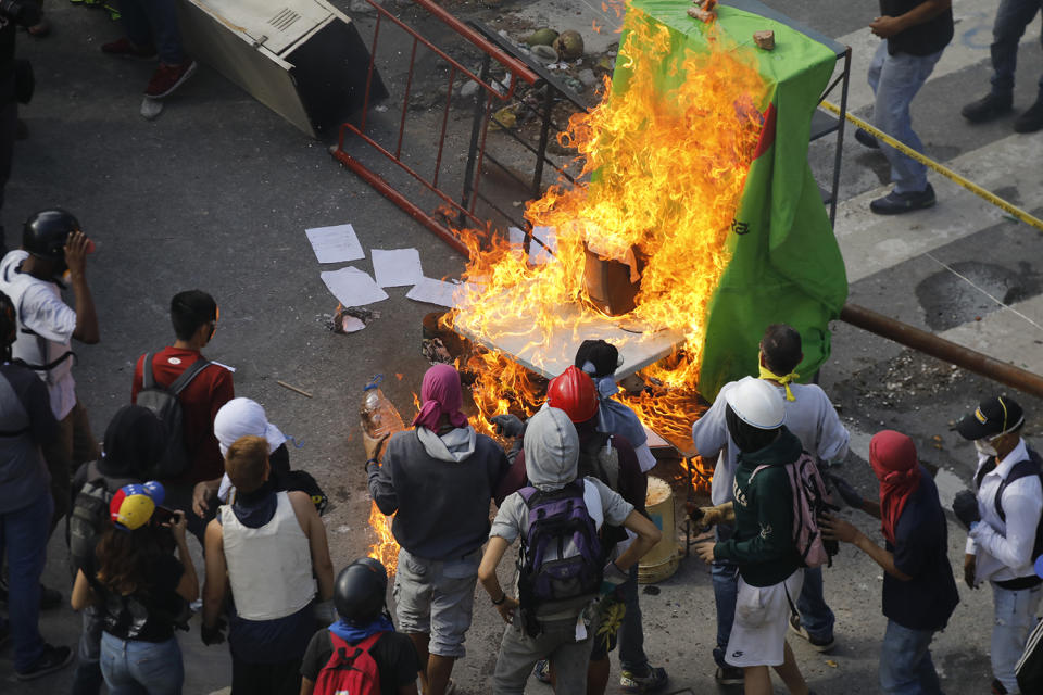 <p>Demonstrators watch a barricade burn after clashes broke out while the Constituent Assembly election is being carried out in Caracas, Venezuela, July 30, 2017. (Carlos Garcia Rawlins/Reuters) </p>