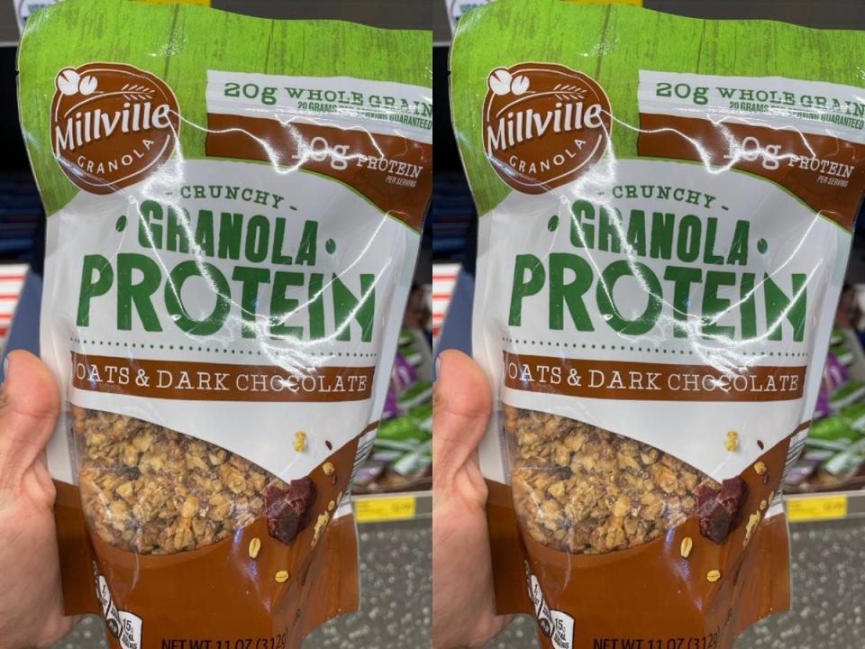 A hand holding a green and brown bag of Millville granola