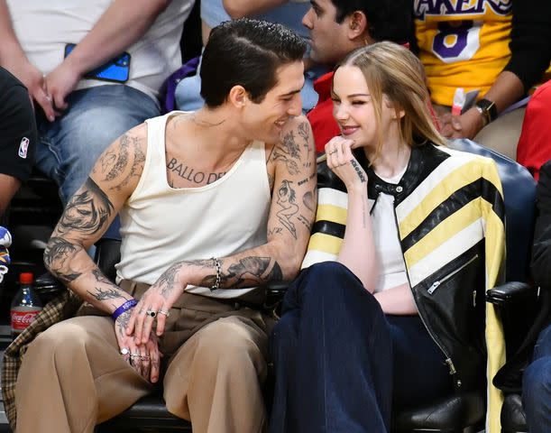 <p>Allen Berezovsky/Getty</p> Damiano David and Dove Cameron at a Los Angeles Lakers game