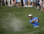 Tiger Woods hits out of a bunker on the 18th hole during the first round of the Honda Classic golf tournament, Thursday, Feb. 27, 2014 in Palm Beach Gardens, Fla. (AP Photo/Wilfredo Lee)