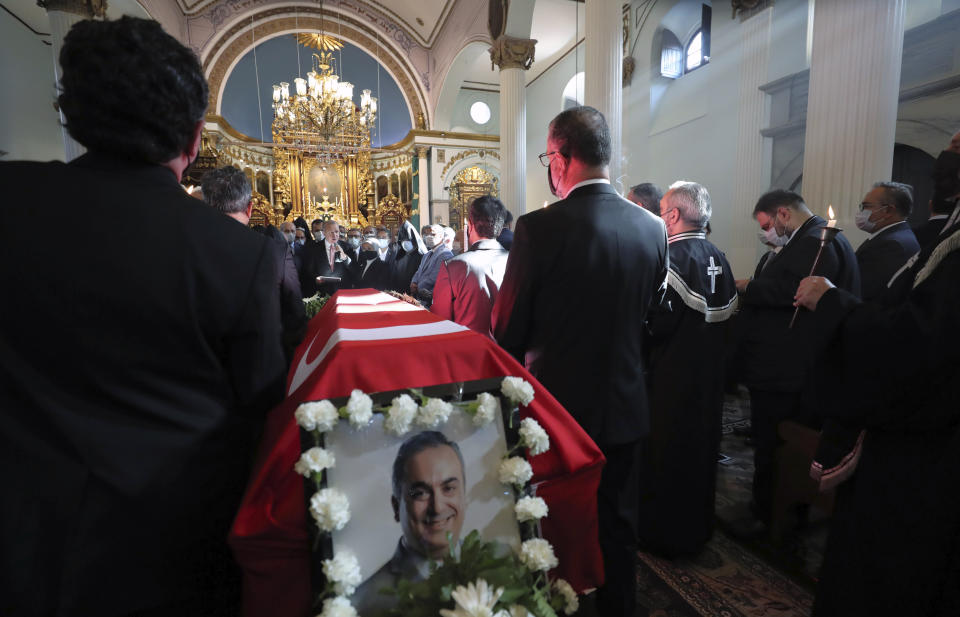 Turkey's President Recep Tayyip Erdogan, rear center, speaks as he attends a funeral ceremony for Markar Esayan, a Turkish lawmaker from Erdogan's ruling Justice and Development Party, who died of cancer at 51, at the Armenian Patriarchate Church, in Istanbul, Thursday, Oct. 22, 2020.(Turkish Presidency via AP, Pool)