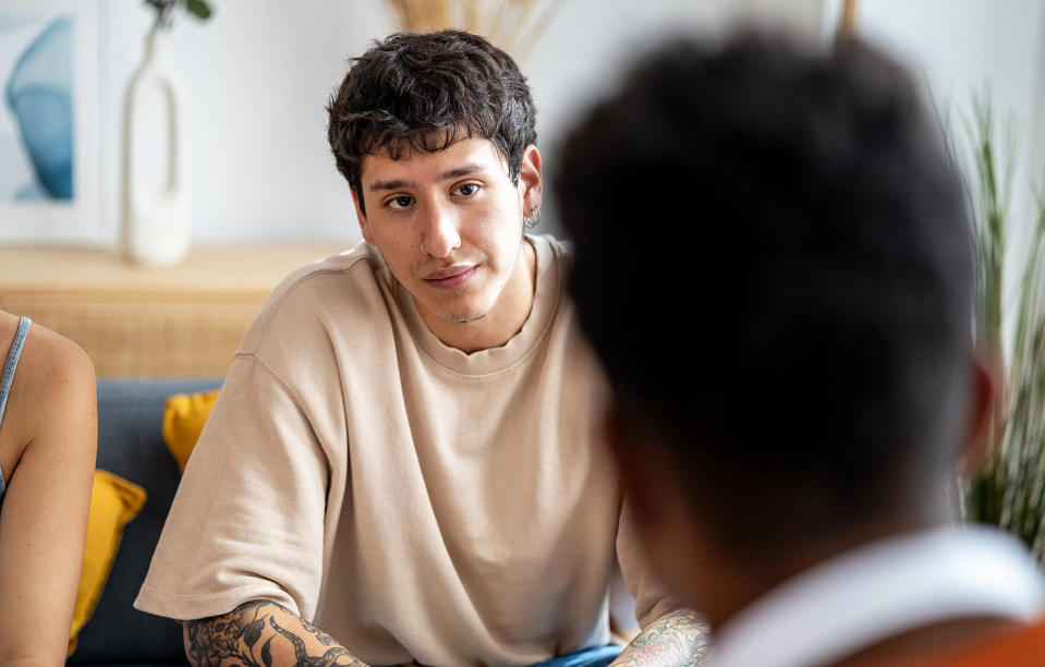 Young man listening to a friend. (Manu Vega / Getty Images)