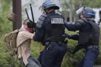 French police apprehend a man during a demonstration to protest the government's proposed labour law reforms in Nantes, France, May 26, 2016. REUTERS/Stephane Mahe