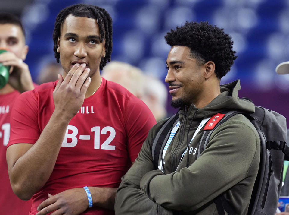 FILE - Ohio State quarterback CJ Stroud, left, talks to Alabama quarterback Bryce Young at the NFL football scouting combine in Indianapolis, Saturday, March 4, 2023. The Panthers packaged two first-round picks, two second-round picks and star receiver D.J. Moore to move up from No. 9 in the draft to the top pick to give Carolina the pick of the lot at quarterback in next week's draft. (AP Photo/Darron Cummings, File)