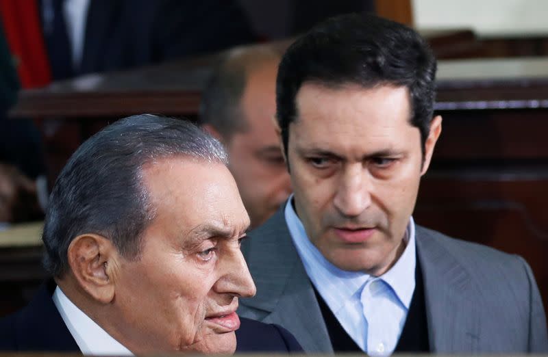 Former Egyptian President Hosni Mubarak arrives with his son Alaa in a court case accusing ousted Islamist president Mohamed Mursi of breaking out of prison in 2011, in Cairo