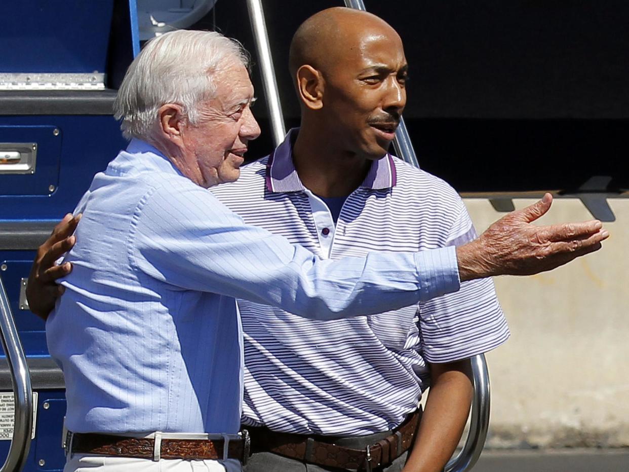 Aijalon Gomes pictured with former US President Jimmy Carter after the latter intervened to bring him home from detention in North Korea: Adam Hunger/Reuters