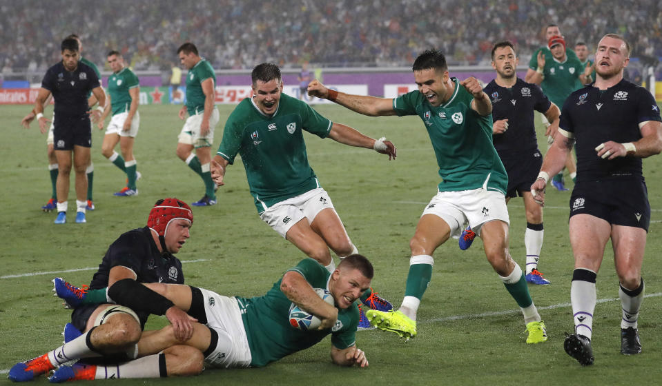 Ireland's Andrew Conway, bottom center, scores a try during the Rugby World Cup Pool A game at International Stadium between Ireland and Scotland in Yokohama, Japan, Sunday, Sept. 22, 2019. (AP Photo/Christophe Ena)