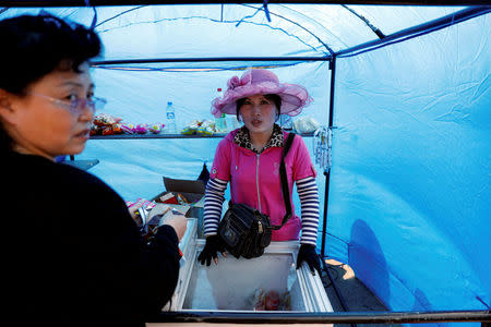 FILE PHOTO: A woman sells snacks in central Pyongyang, North Korea April 16, 2017. REUTERS/Damir Sagolj/File Photo