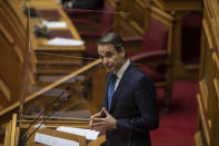 Greek Prime Minister Kyriakos Mitsotakis speaks during a parliamentary session in Athens, Thursday, Feb. 25, 2021. Mitsotakis has promised to outline proposed legal changes in parliament on Thursday to make it easier for victims of sexual assault to report the crimes. (AP Photo/Petros Giannakouris)