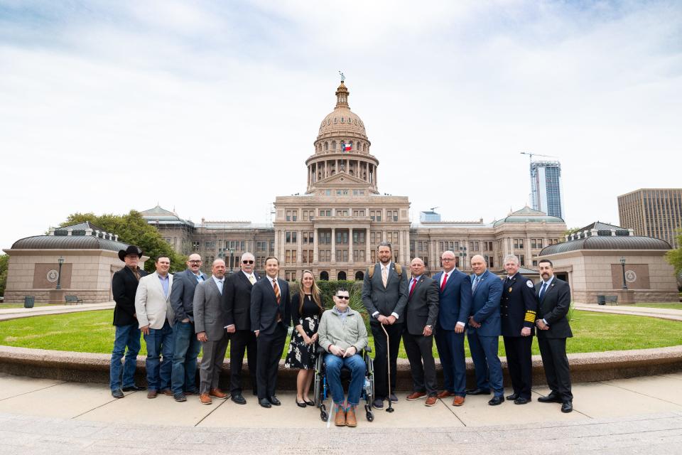 Retired Lubbock firefighter Matt Dawson, center, and wife Chanda joined Rep. Dustin Burrows, sixth from left, in Austin for a Texas House committee hearing on the Matt Dawson Act on March 20, 2023. Lubbock Fire Chief Shaun Fogerson, second from right, testified during the hearing.