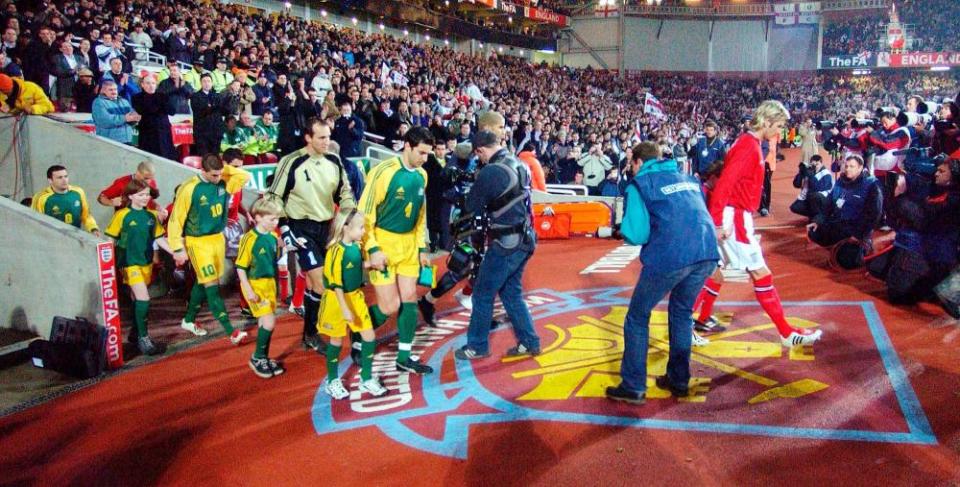 Then England captain David Beckham and Australia captain Paul Okon lead the teams out of the tunnel and on to the pitch at Upton Park in 2003