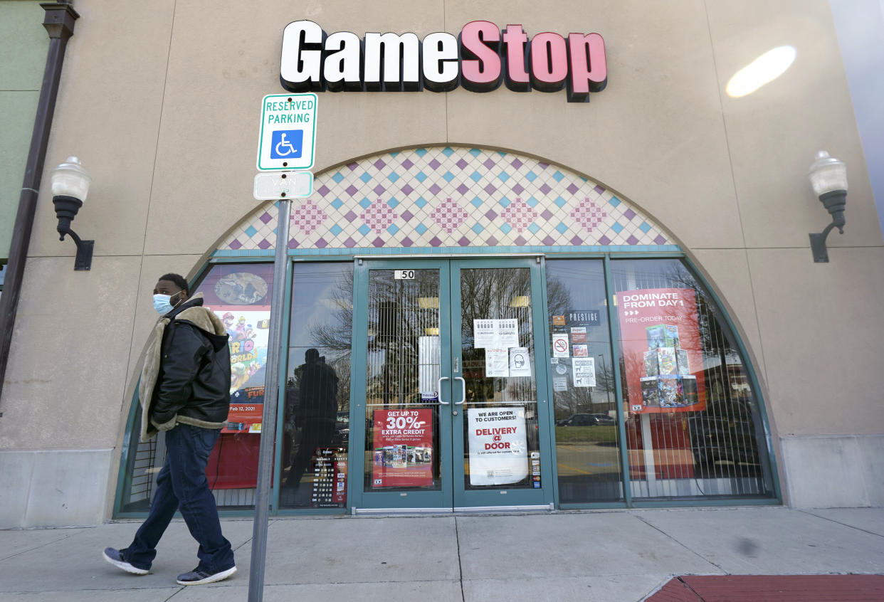 A GameStop storefront is shown before opening Thursday morning, Jan. 28, 2021, in Dallas. The online trading platform Robinhood is moving to restrict trading in GameStop and other stocks that have soared recently due to rabid buying by smaller investors. GameStop stock has rocketed from below $20 to around $350 this month as a volunteer army of investors on social media challenged big institutions who has placed market bets that the stock would fall. (AP Photo/LM Otero)