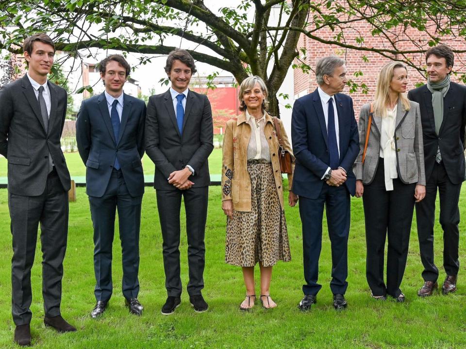 LVMH CEO Bernard Arnault poses with five children and wife outside