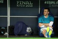 <p>Gareth Bale cuts a lonely figure on the Real Madrid bench </p>