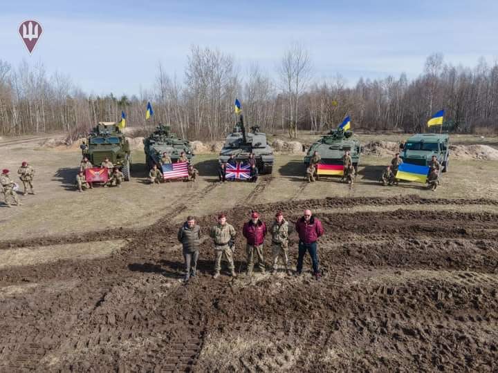 Defense Minister Oleksii Reznikov and members of Ukraine's military pose in front of the first Challenger 2 tanks to arrive in Ukraine along with other military vehicles. (Photo: Defense Ministry / Facebook)