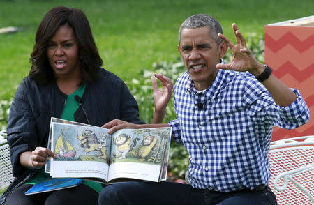 U.S. President Barack Obama and first lady Michelle Obama perform a reading of the children's book "Where the Wild Things Are" for children gathered for the annual White House Easter Egg Roll on the South Lawn of the White House in Washington, March 28, 2016. REUTERS/Yuri Gripas