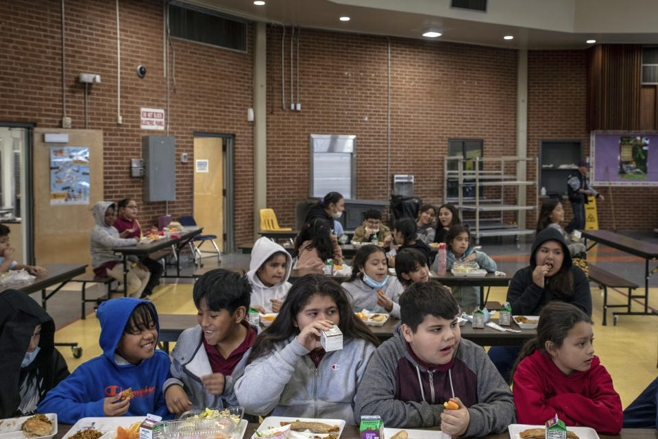 Students eat lunch in the cafeteria at V. H. Lassen Academy of Science and Nutrition in Phoenix, Tuesday, Jan. 31, 2023, in Phoenix. (AP Photo/Alberto Mariani)