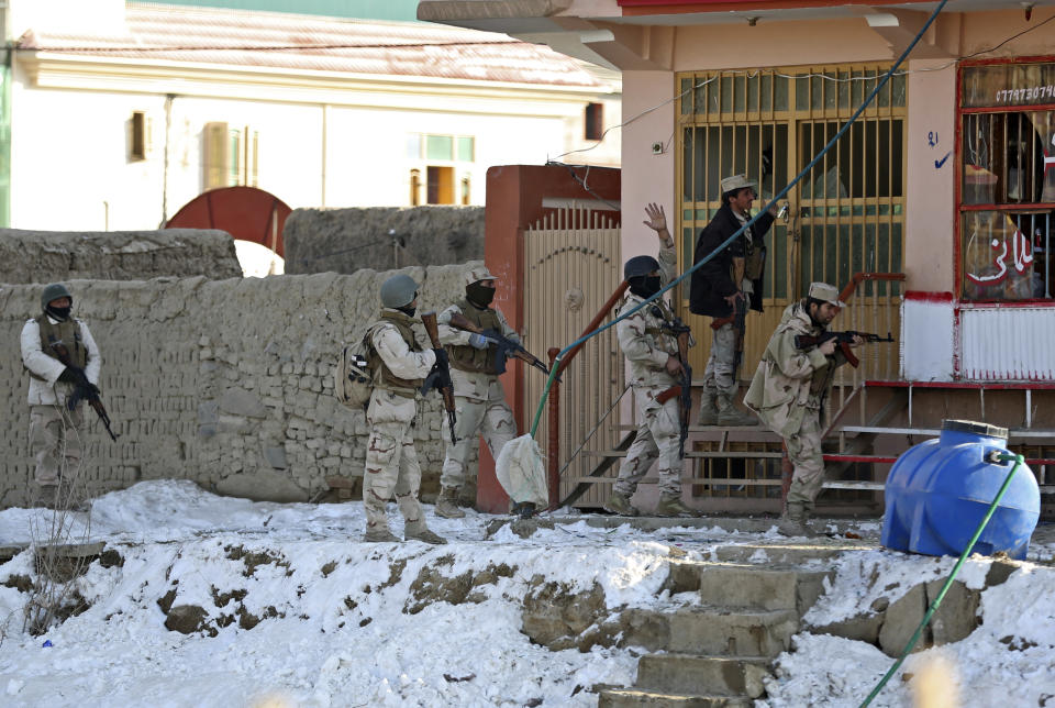 Afghan security forces search the site of a suicide bombing that struck near a NATO convoy in the Afghan capital Kabul, Afghanistan, Monday, Feb. 10, 2014. Taliban-affiliated militants have stepped up attacks in the final year of the international coalition’s 13-year combat mission in Afghanistan, seeking to shake confidence in the Kabul government’s ability to keep order after they assumed full security responsibility last year. (AP Photo/Massoud Hossaini)