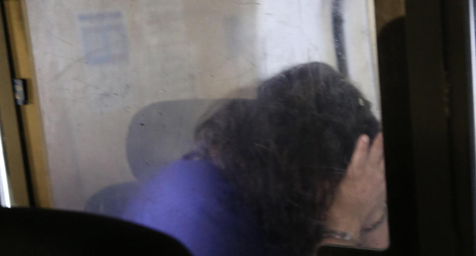 The 26-year-old woman pictured being taken to Newtown police station.
