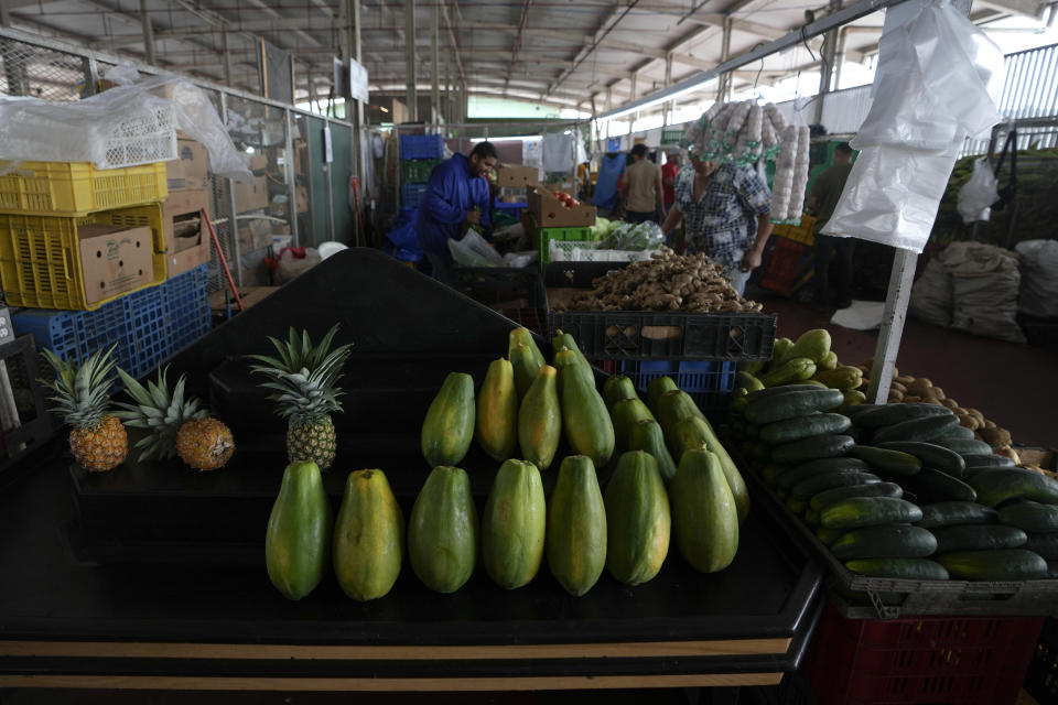 Pineapples and papayas are displayed for sale at a market in Panama City, Wednesday, July 20, 2022. A third week of protests and highway blockades have begun to impact the supply of food and other items in parts of Panama. (AP Photo/Arnulfo Franco)