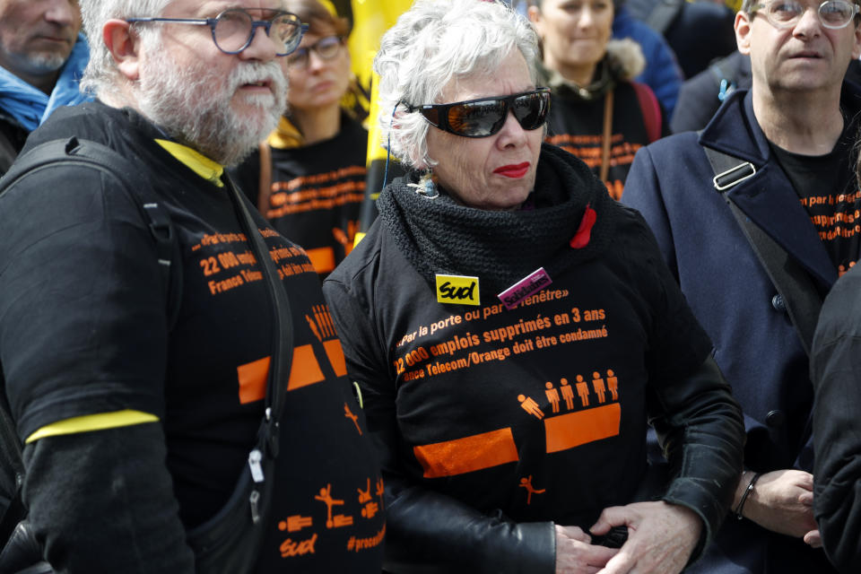 French unions members demonstrate at the start of the trial of French group France Telecom in front of the Paris' courthouse, Monday, May 6, 2019. French telecom giant Orange and seven former or current managers are going on trial accused of moral harassment over a wave of employee suicides a decade ago. (AP Photo/Thibault Camus)