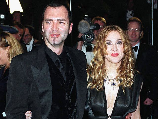 <p>John Chaple/Getty</p> Madonna and her brother arrive at the Vanity Fair Oscar Party at Mortons March 23, 1998 in West Hollywood, California.