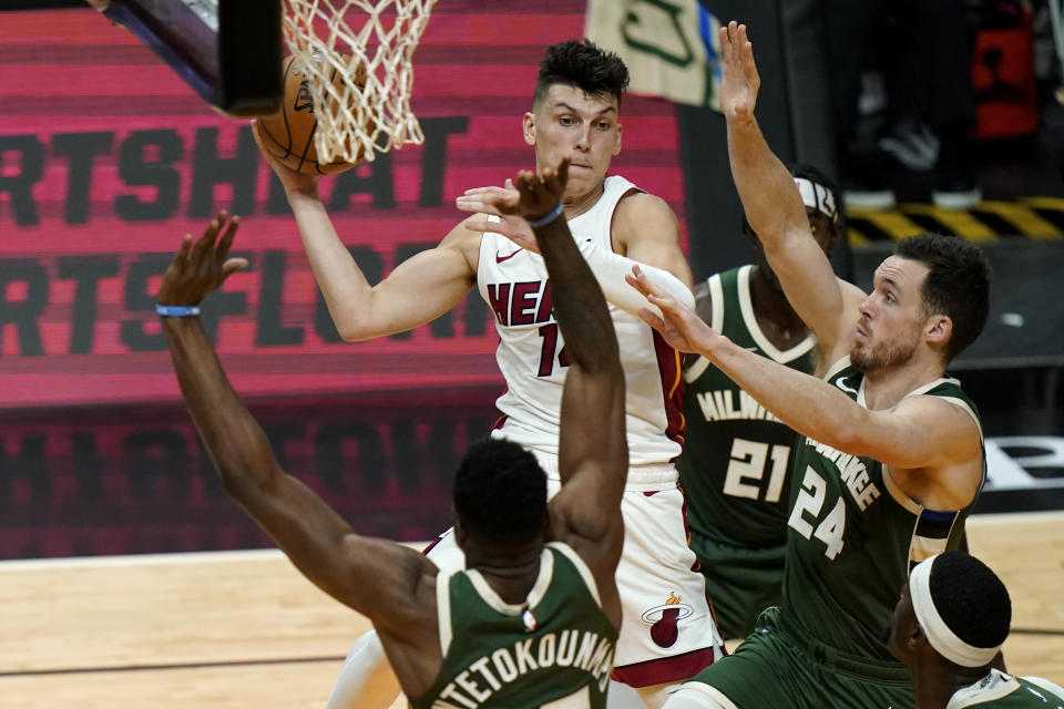 Miami Heat guard Tyler Herro, left rear, goes to the basket as Milwaukee Bucks forward Thanasis Antetokounmpo, left, and guard Pat Connaughton (24) defend during the first half of an NBA basketball game Wednesday, Dec. 30, 2020, in Miami. (AP Photo/Lynne Sladky)